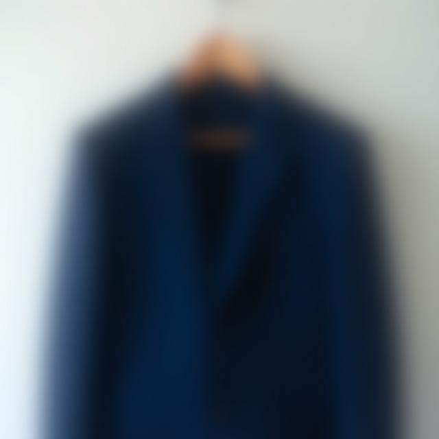 Elegant formal navy blue suit on hanger